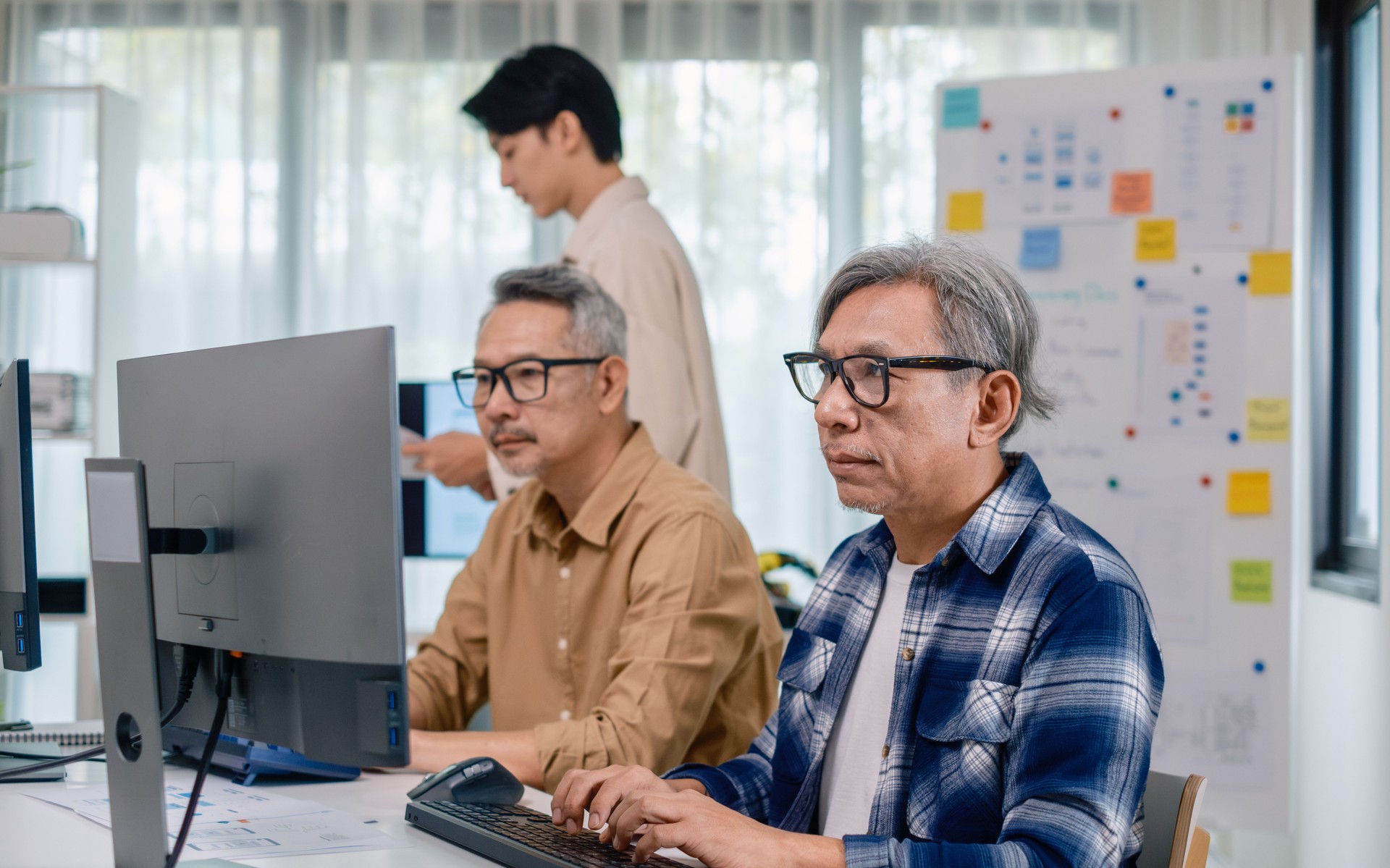 Group of asian senior learning programming software development analyzing  flowcharts  during a bootcamp training